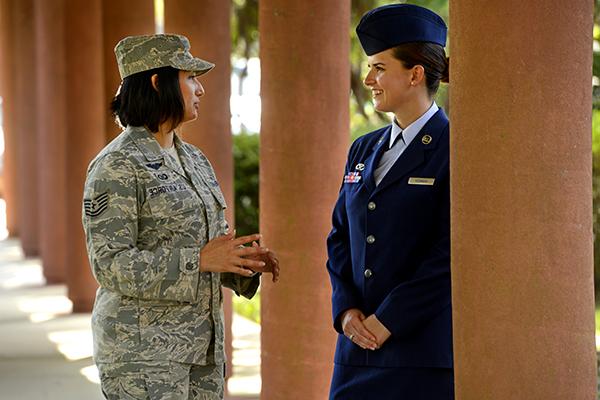 two rotc students conversing under a covered outdoor walkway